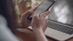 close up hands typing on mobile phone and scrolls through social media feed free video