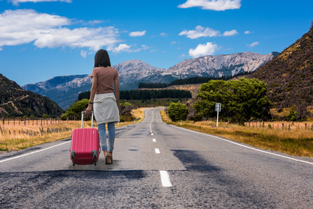 93751733 woman walking alone on highway road at countryside without destination concept run away home